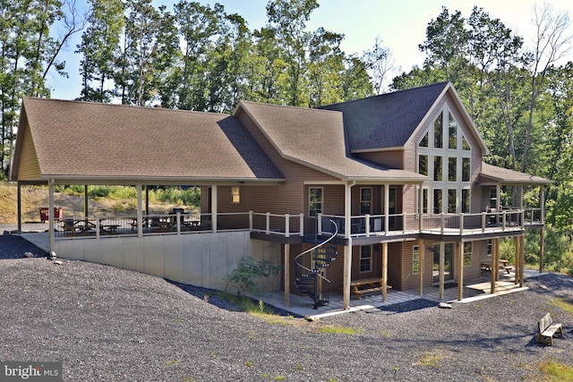 view of front facade with a deck and a patio