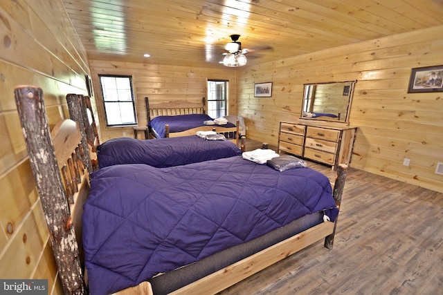 bedroom with wood-type flooring, wooden walls, and wood ceiling