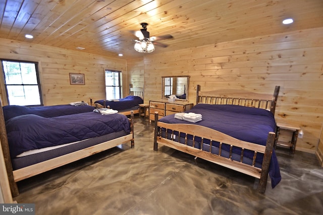 bedroom featuring wooden walls, concrete floors, and wooden ceiling