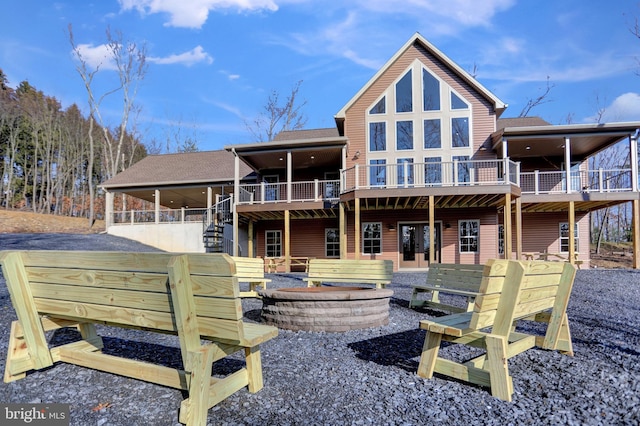 rear view of house with an outdoor fire pit