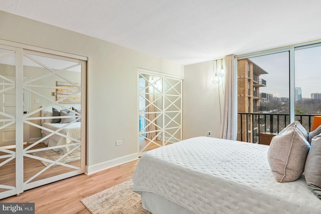 bedroom with wood-type flooring and a textured ceiling