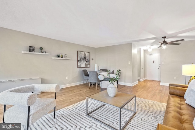 living room featuring hardwood / wood-style flooring and ceiling fan