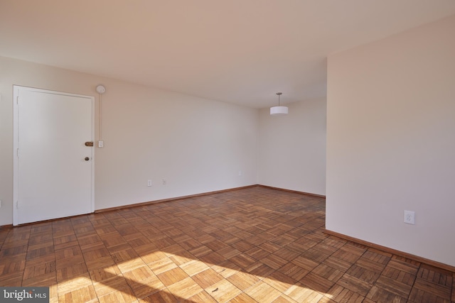 spare room with dark parquet flooring