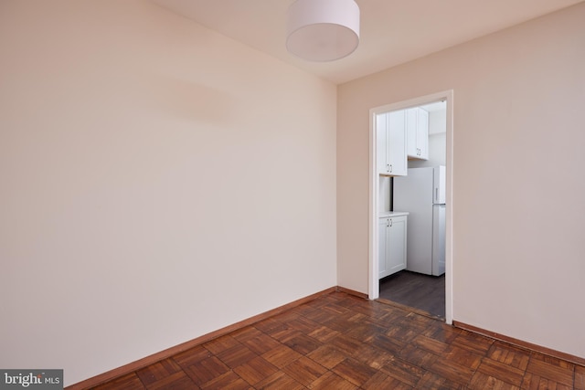 empty room featuring dark parquet flooring