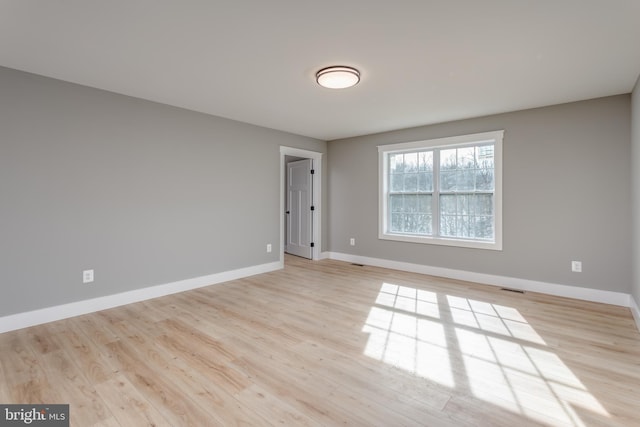 unfurnished room with light wood-type flooring