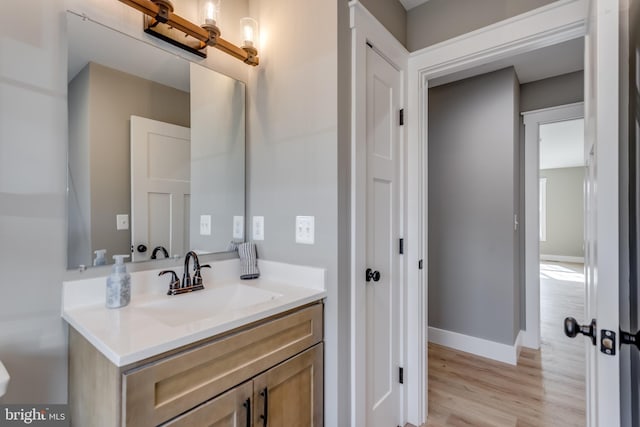 bathroom featuring hardwood / wood-style flooring and vanity