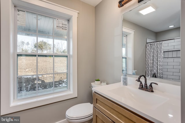 bathroom featuring vanity, curtained shower, and toilet