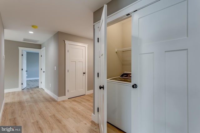 washroom with washer / clothes dryer and light hardwood / wood-style flooring