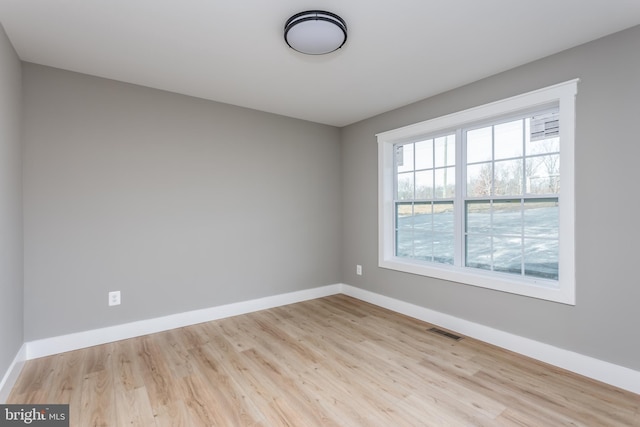 unfurnished room featuring light hardwood / wood-style floors