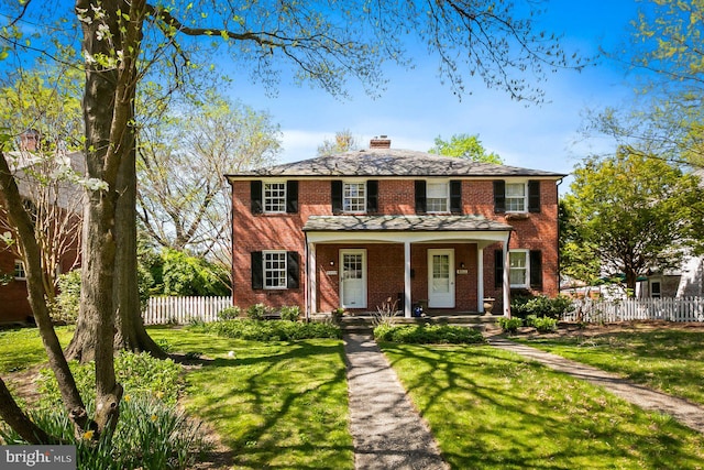 colonial-style house with a front yard