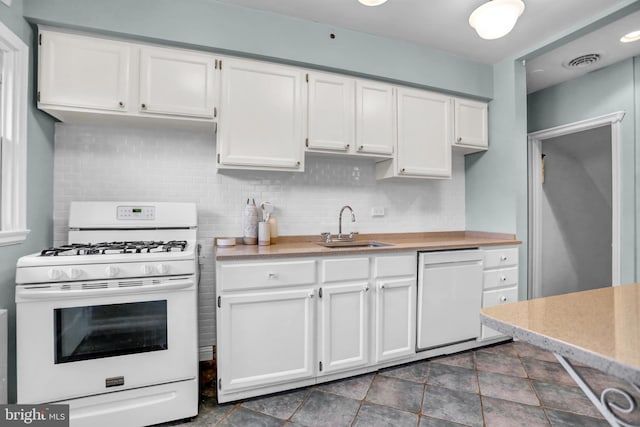 kitchen with white cabinetry, sink, white appliances, and decorative backsplash