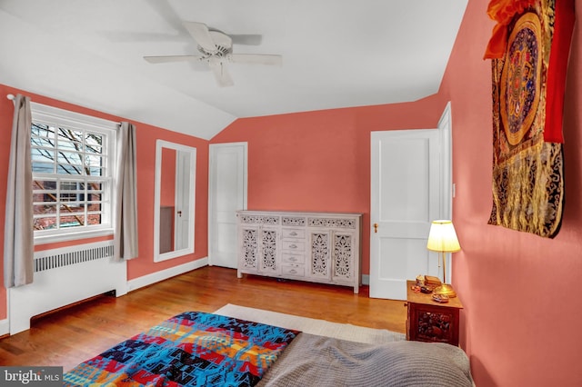 bedroom featuring ceiling fan, vaulted ceiling, and light wood-type flooring