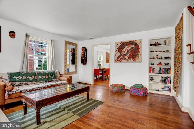 living room featuring hardwood / wood-style flooring and built in features