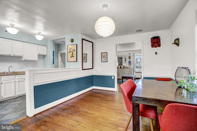 dining room featuring sink and hardwood / wood-style floors