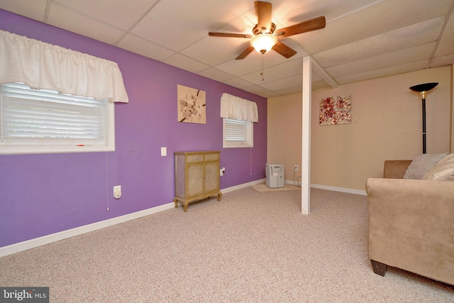 unfurnished room featuring light carpet, a ceiling fan, a paneled ceiling, and baseboards