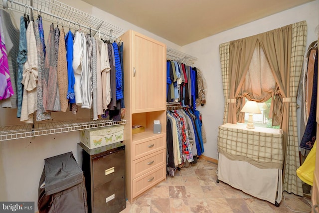 spacious closet with stone finish flooring