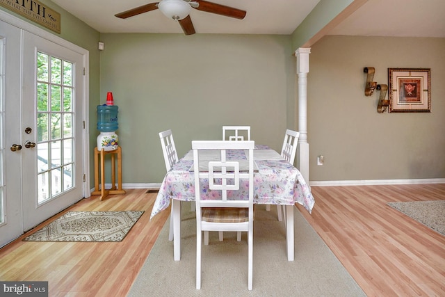 dining space with ceiling fan, baseboards, wood finished floors, and french doors