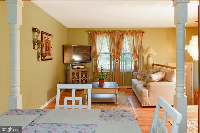 living room with baseboards and light wood-style floors