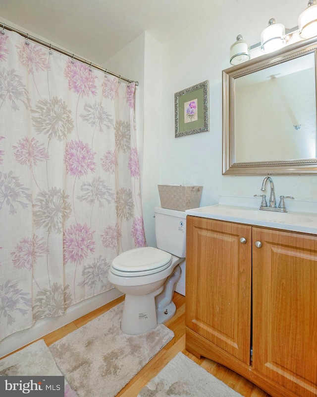 full bathroom with toilet, curtained shower, and vanity