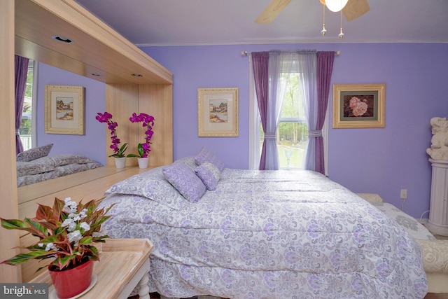 bedroom with ceiling fan and crown molding