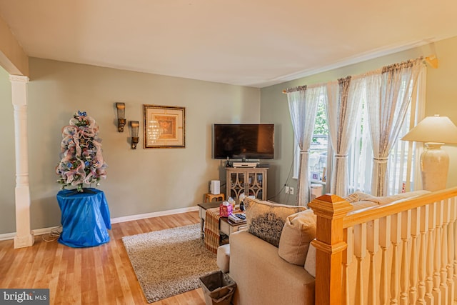 living area featuring baseboards and wood finished floors