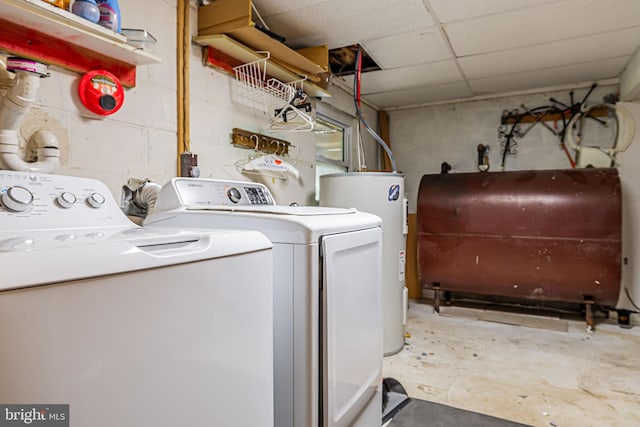 laundry room with heating fuel, laundry area, washer and clothes dryer, and electric water heater