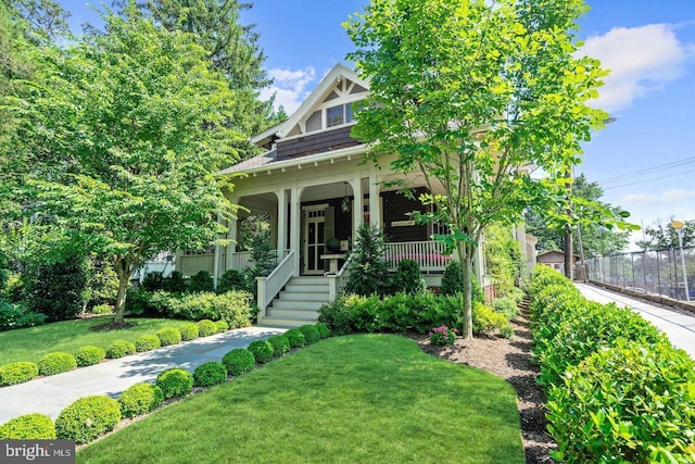 view of front of house with covered porch and a front yard