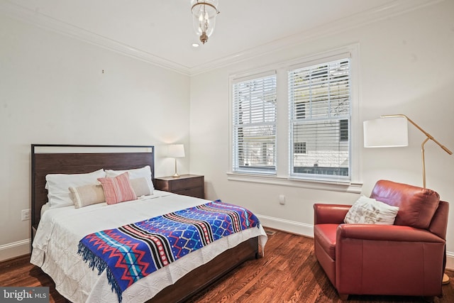 bedroom featuring baseboards, wood finished floors, and ornamental molding