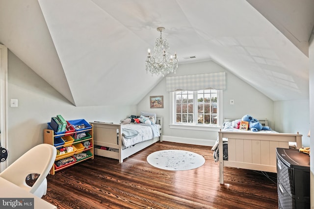 bedroom featuring visible vents, baseboards, vaulted ceiling, an inviting chandelier, and wood finished floors