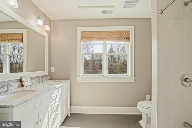 bathroom with a sink, visible vents, and plenty of natural light