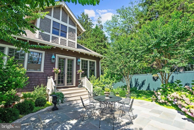 back of property with a patio and fence