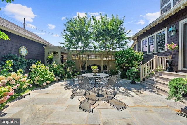 view of patio featuring outdoor dining space and fence