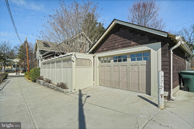 detached garage featuring fence