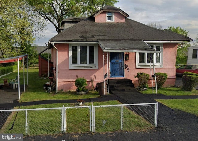 bungalow-style home featuring a front yard