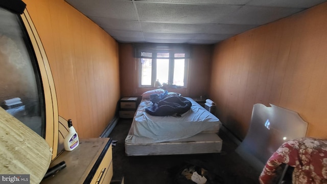 bedroom featuring wooden walls