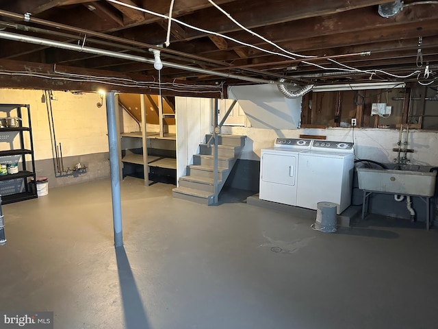 basement with sink and washing machine and dryer