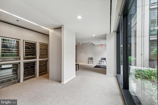 interior space featuring wine cooler and light colored carpet