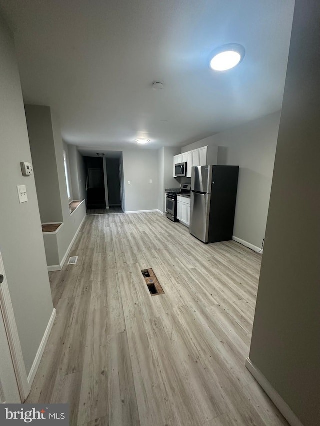 unfurnished living room with light hardwood / wood-style flooring