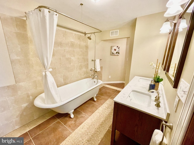 bathroom with shower / tub combo with curtain, tile patterned floors, and vanity