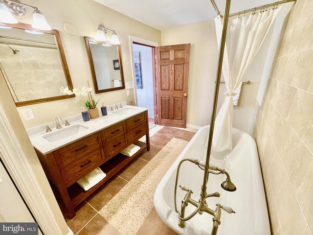 bathroom featuring vanity, a tub, and tile patterned floors