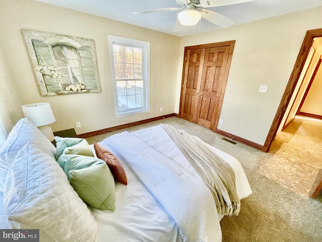 carpeted bedroom with ceiling fan and a closet