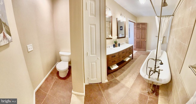 bathroom with vanity, tile patterned floors, and toilet