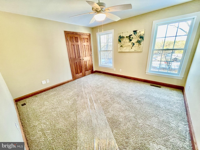 carpeted empty room with ceiling fan