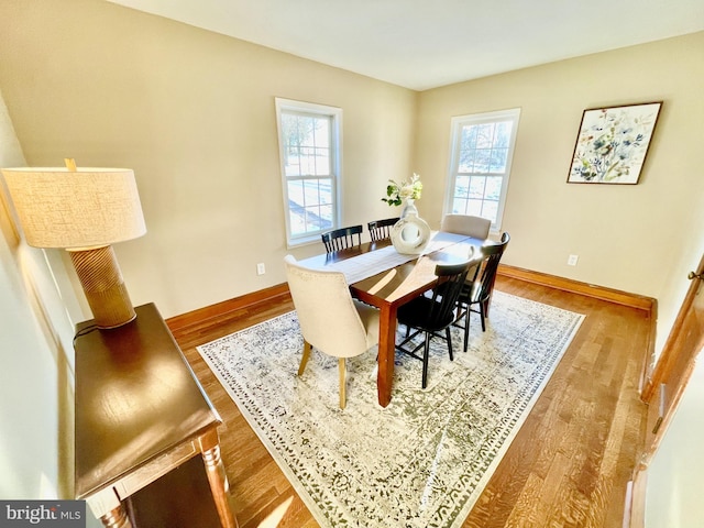 dining space featuring hardwood / wood-style flooring and a healthy amount of sunlight