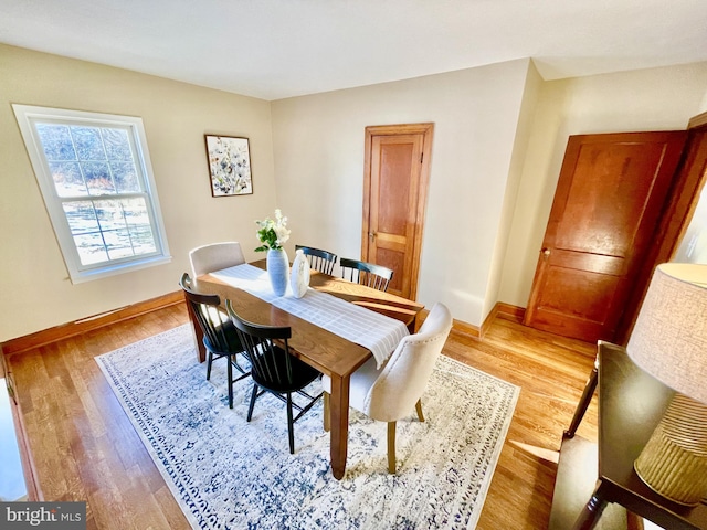 dining space featuring light wood-type flooring