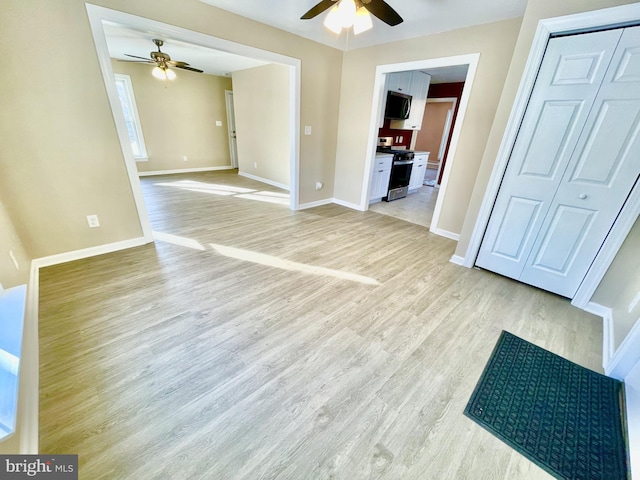 spare room featuring light hardwood / wood-style floors and ceiling fan