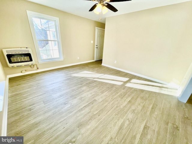 unfurnished living room with ceiling fan, light hardwood / wood-style floors, and heating unit