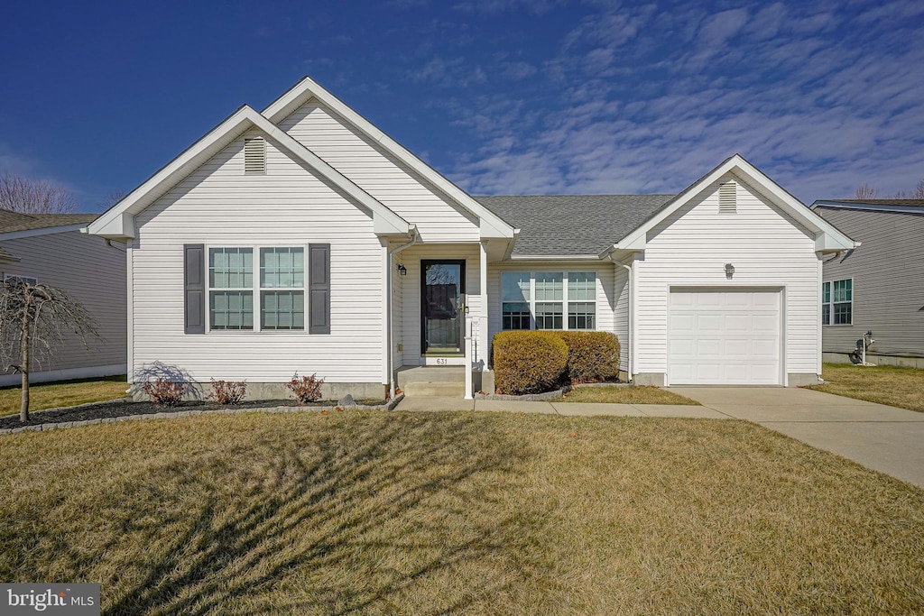 view of front of property with a garage and a front yard