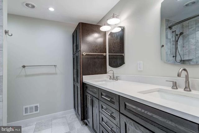 bathroom featuring vanity and tiled shower