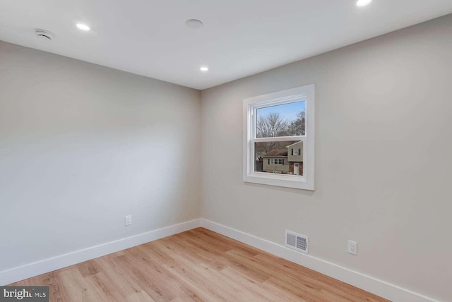 spare room featuring light wood-type flooring